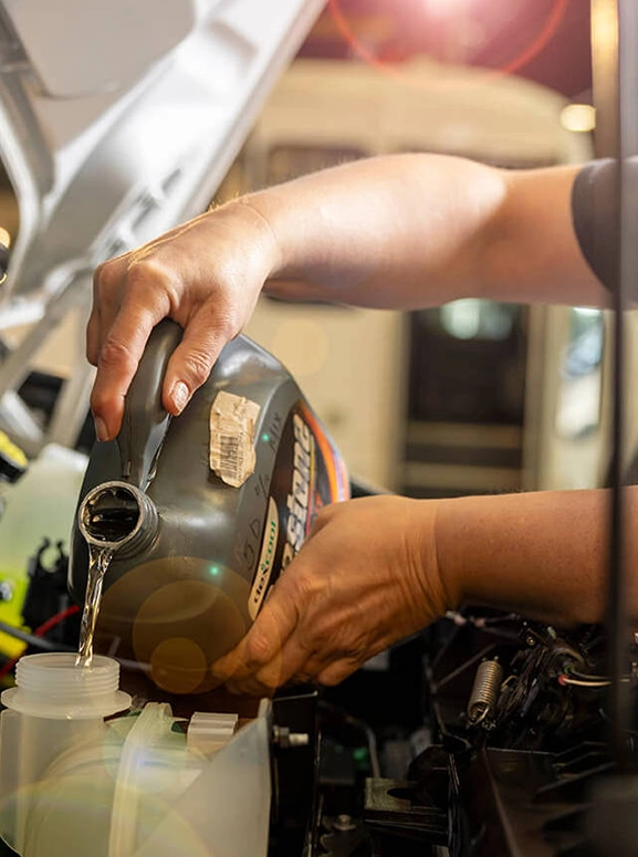 Liquid being poured into a spout inside an engine