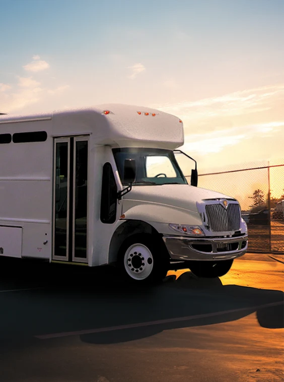 White shuttle bus parked next to a security fence at a prison near Jacksonville